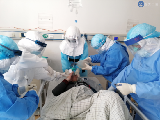 李立斌主任（中）戴著正壓頭套，為新冠肺炎危重癥病人